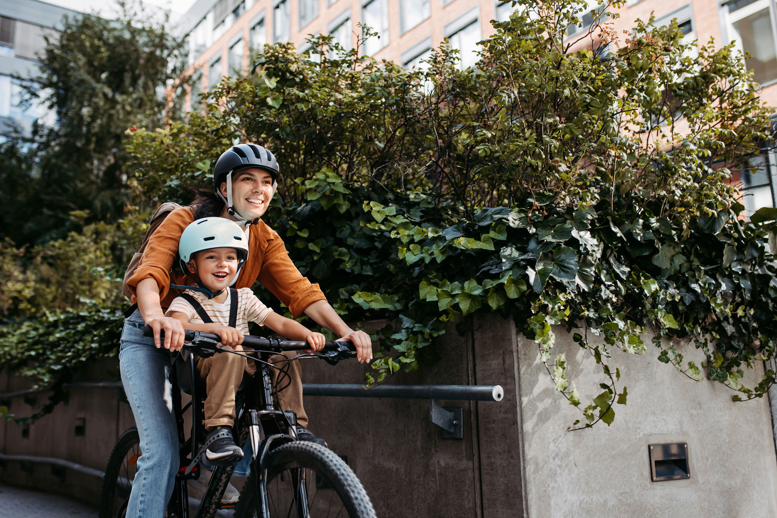 A mother with a young son bicycling